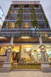 a tall building with plants on the side of it at Sino Inn Phuket Hotel - SHA Plus in Phuket