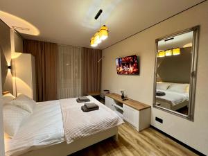 a bedroom with a bed and a large mirror at Chișinău Airport Comfort in Chişinău