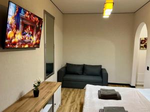 a living room with a couch and a tv at Chișinău Airport Comfort in Chişinău