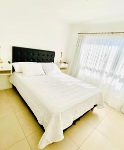 En eller flere senge i et værelse på Departamento Necochea