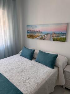 a bedroom with a bed with a painting on the wall at Casa Ventura in Lagos