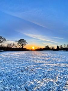 een sneeuwveld met zonsondergang op de achtergrond bij The Pods at 7 Black Crofts in Oban