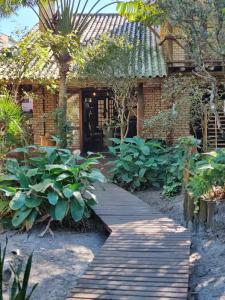 a walkway in front of a house with plants at Hospedaria LARENA in Florianópolis