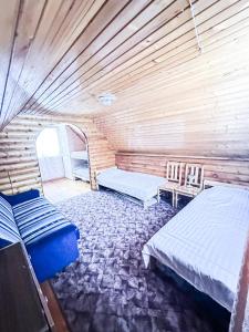 a room with two beds and a table and chairs at Anetes pirts in Jaunanna