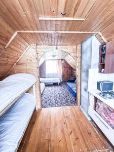 a room with two bunk beds in a tiny house at Anetes pirts in Jaunanna
