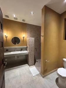 a bathroom with a sink and a toilet and a mirror at Casa Colibrí in Zipolite +15 photos