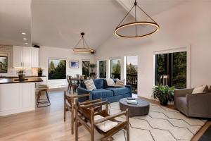 a living room and kitchen with a blue couch at Abode at Rendezvous in Teton Village