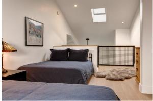 a bedroom with two beds and a lamp and a rug at Abode at Rendezvous in Teton Village