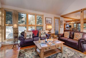 a living room with leather couches and a table at Abode at Moose Creek #21 in Teton Village