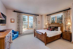 a bedroom with a bed and a large window at Abode at Moose Creek #21 in Teton Village