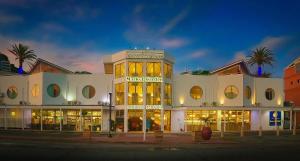 a large white building with many windows on a street at Commodore Suites, SureStay Collection by Best Western in Simpson Bay