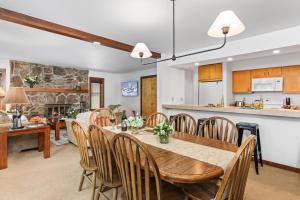 a dining room and kitchen with a table and chairs at Abode at Sundance in Teton Village