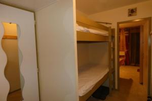 a room with two bunk beds and a doorway at Le refuge 66 in Saint-Aventin