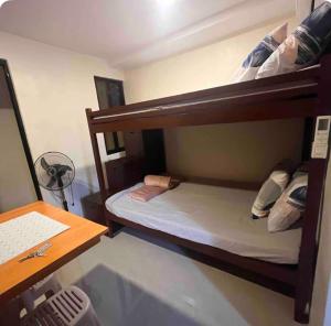 a bedroom with two bunk beds and a desk at Studio Apartment in Mactan, Cebu Room304 in Lapu Lapu City