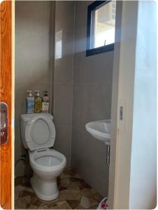 a small bathroom with a toilet and a sink at Studio Apartment in Mactan, Cebu Room304 in Lapu Lapu City +12 photos