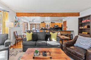 a living room with a couch and a table at Abode at Fish Creek in Wilson