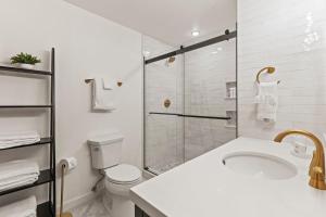 a bathroom with a shower and a toilet and a sink at Abode at Fish Creek in Wilson +56 photos