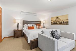 a bedroom with a bed and a couch at Abode at Fish Creek in Wilson