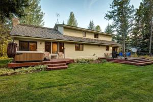 a house with a deck and a yard withgrass at Abode at Fish Creek in Wilson