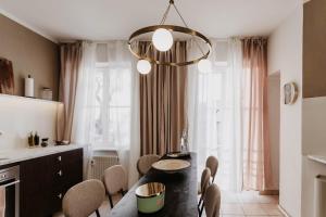 a kitchen with a dining room table and chairs at Designer Loft am Dessauer Hauptbahnhof in Dessau