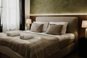 a bedroom with a large bed with two pillows on it at Designer Loft am Dessauer Hauptbahnhof in Dessau