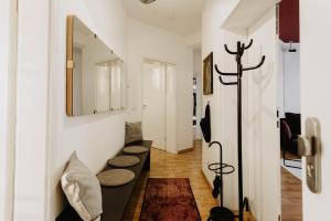 a hallway with a row of benches and a mirror at Designer Loft am Dessauer Hauptbahnhof in Dessau
