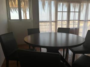 a dining room with a round table and chairs at Casa Vichayito - Los Órganos in Los Órganos
