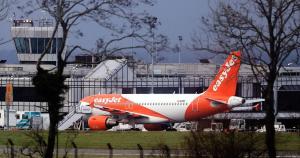 an orange and white airplane is parked at an airport at Cosy Cabin - Near Belfast International Airport in Aldergrove +1 photo