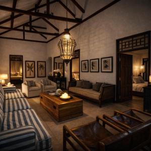 a living room with a couch and a table at Villa Andia in Gili Islands