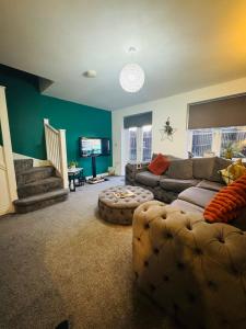 a living room with a couch and a tv at The Woodlands 3bed 2bath in Langley Park