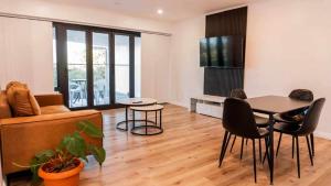a living room with a table and a couch at Lagoon Apartments in Nuku‘alofa