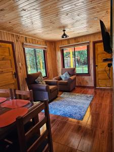 a living room with couches and a dining room at Las Victorias in Salto del Laja