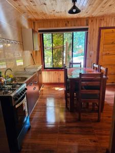 a kitchen with a table and a dining room at Las Victorias in Salto del Laja
