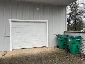 two trash cans sitting next to a garage at Montgomery Apartment in Redding +11 photos