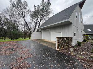 a white house with a driveway in front of it at Montgomery Apartment in Redding
