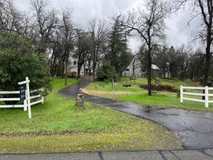 a winding road with a white fence and a fire hydrant at Montgomery Apartment in Redding