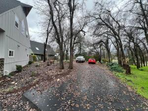 a driveway with a red car parked next to a house at Montgomery Apartment in Redding