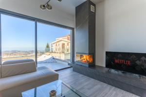 a living room with a fireplace and a couch at Faqra -2BR Hideaway in Ḩaqlat as Sayyid