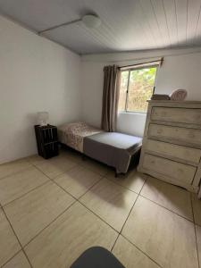 a bedroom with a bed and a window and a dresser at Moramay 2 in Punta del Este