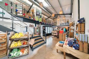 a grocery store aisle with bananas and other groceries at Blacksmiths Cottage by Birch Stays in Needwood
