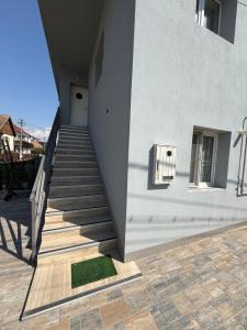 a stairway leading up to a white building at Bee house 12 in Odorheiu Secuiesc