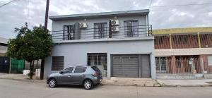 a small car parked in front of a building at Tempo Suites in Córdoba