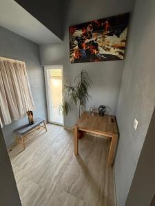 a living room with a wooden table and a bench at Bee house 12 in Odorheiu Secuiesc +2 photos