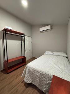 a bedroom with a large bed and a mirror at Quinta Los 3 Tesoros in San Francisco Amatepe