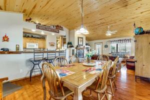 a dining room and kitchen with a wooden table and chairs at Hike, Fish & Enjoy Pond On-Site: Bison Ranch Cabin in Overgaard +28 photos