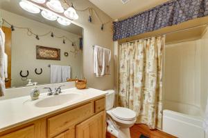 a bathroom with a sink and a toilet and a shower at Hike, Fish & Enjoy Pond On-Site: Bison Ranch Cabin in Overgaard
