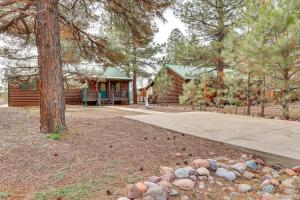 a log cabin with a tree and a driveway at Hike, Fish & Enjoy Pond On-Site: Bison Ranch Cabin in Overgaard