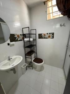 a bathroom with a toilet and a sink at Suite María Paula in Colombia +11 photos