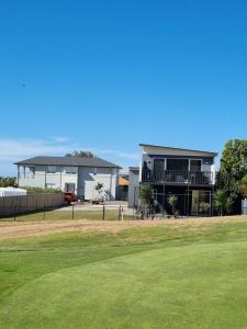 a house with a green yard in front of it at 3rd On Troon in Normanville
