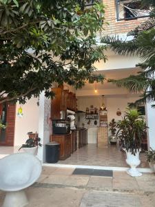 a kitchen with wooden cabinets and plants in a building at Pousada Paracuru Surf in Paracuru